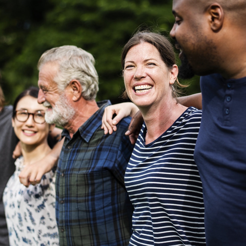 Group of Happy People with Arms Around Each Other's Shoulders