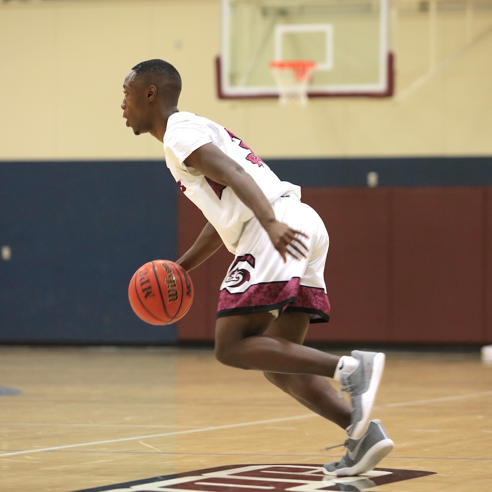 MPC Basketball Player Dribbling Ball in Campus Gymnasium