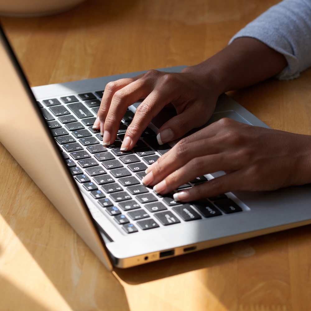 Person Typing on Laptop